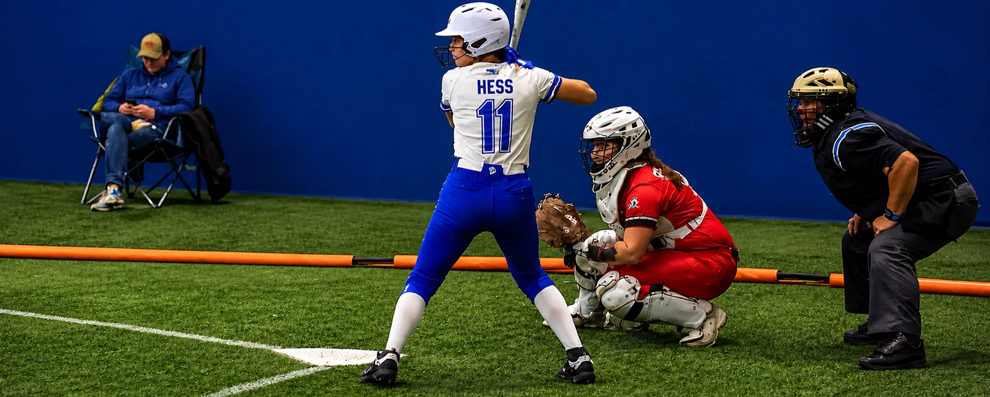 Youth Softball players gathered on indoor turf