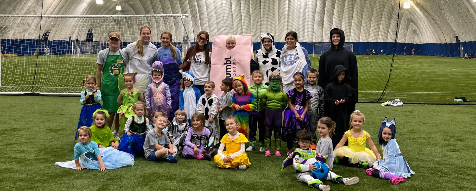 Costumed children and staff gathered on the Rossford Dome turf
