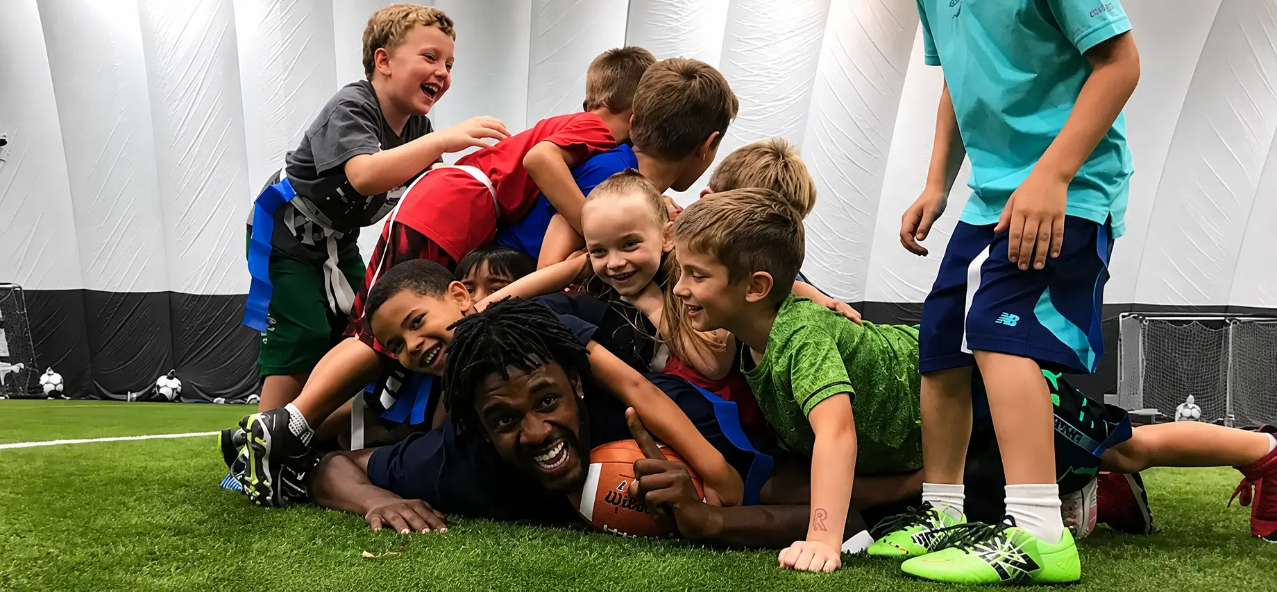 Kids celebrating together on the indoor turf
