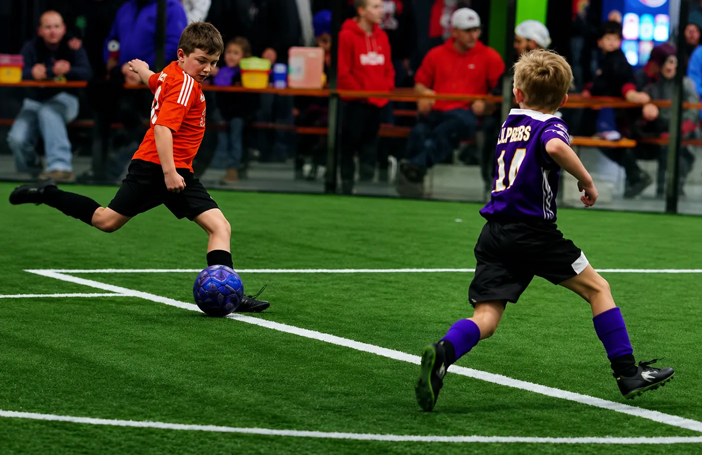 Soccer league players competing indoors