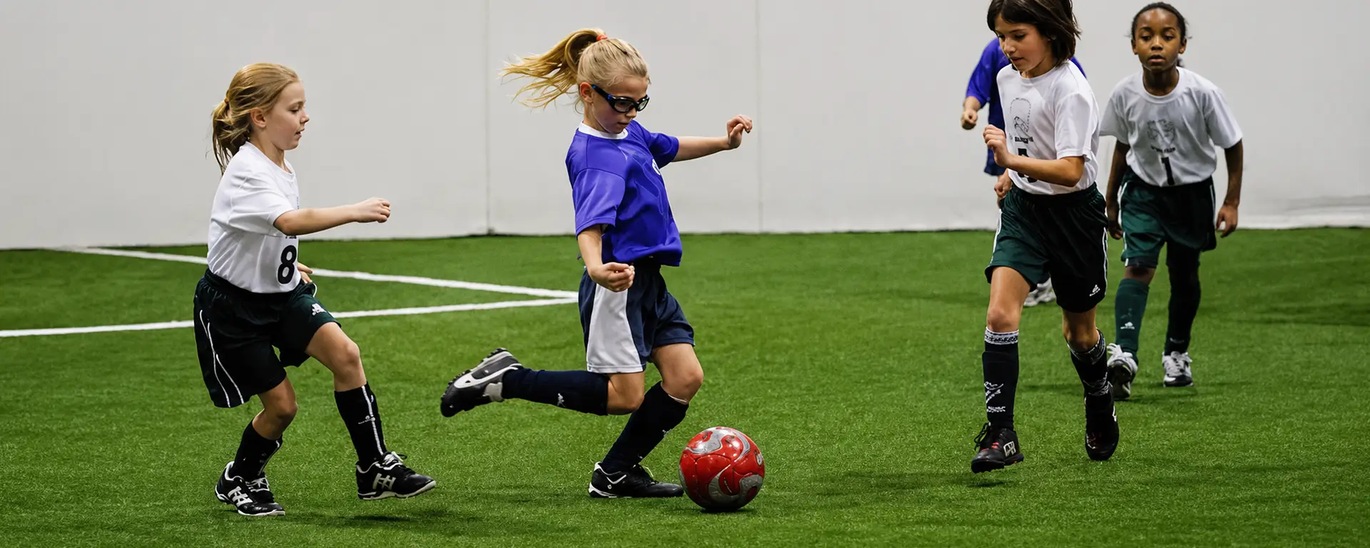 Youth soccer players competing indoors at Soccer Centre