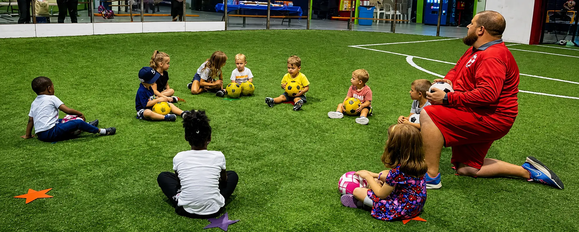 Young Soccer Stars Academy players learning with their coach